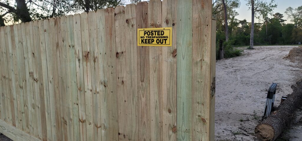 Fence with "Posted no trespassing, keep out" sign